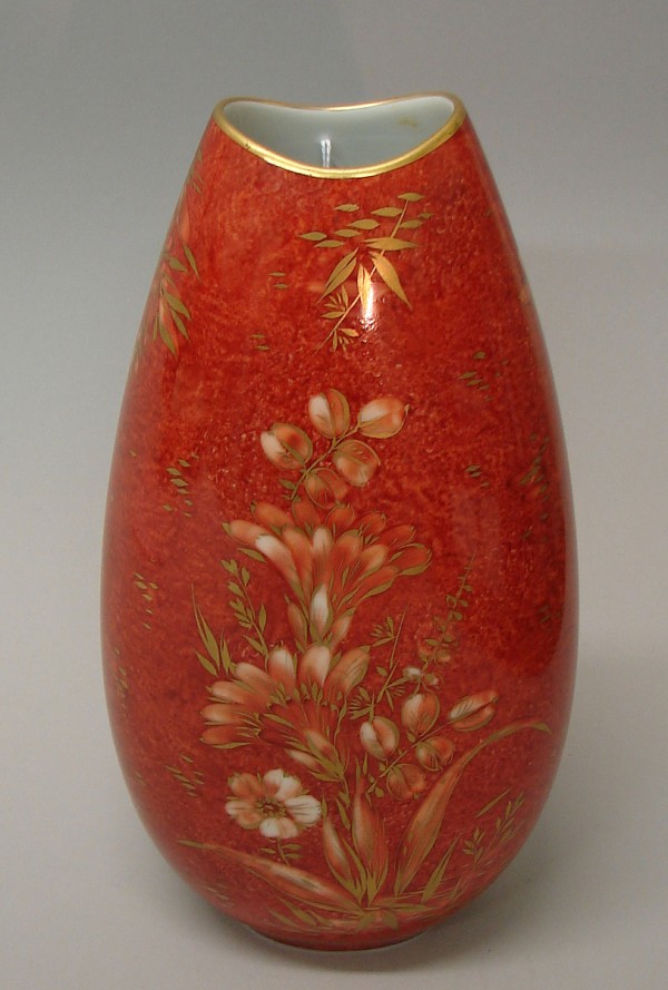 Appraisal: Vase features red ground with floral motif decoration gilt accents