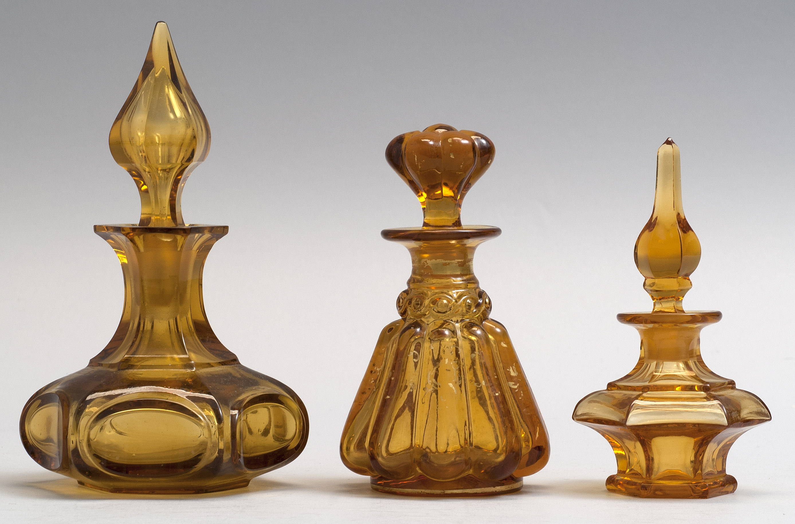 Appraisal: THREE BLOWN-MOLDED GLASS COLOGNE BOTTLES Probably European Last Half of