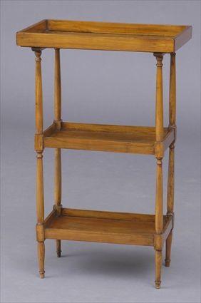 Appraisal: DIRECTOIRE WALNUT THREE-TIER TABLE The rectangular top with wooden gallery