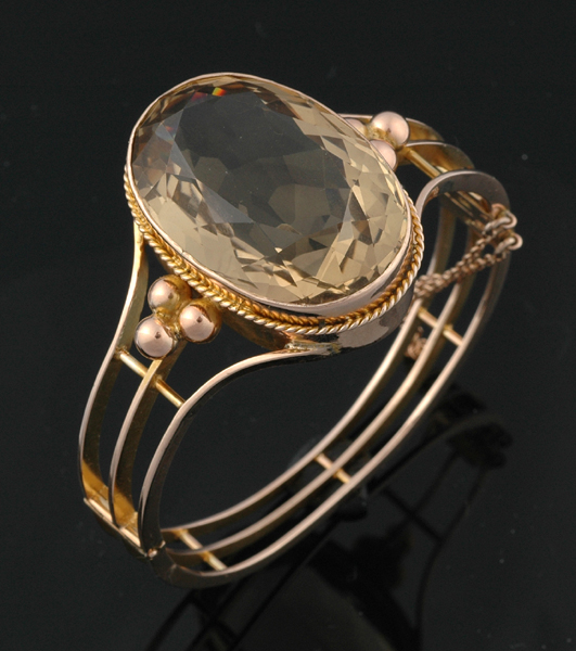 Appraisal: A citrine and gold bangle The ct gold hinged bangle