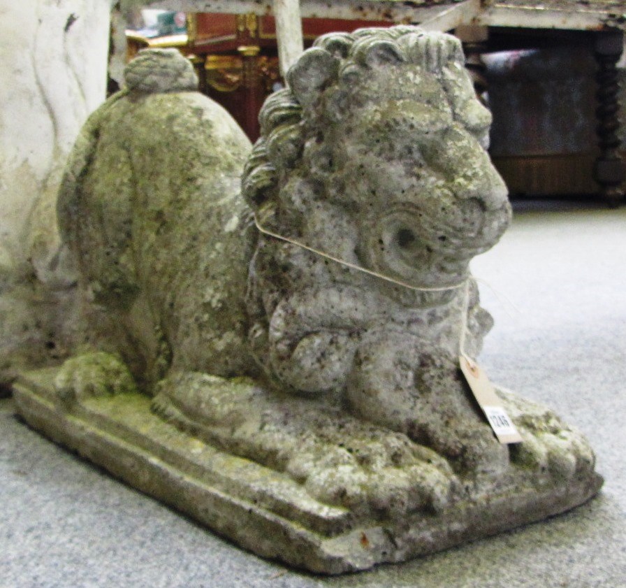 Appraisal: A pair of reconstituted stone figures of lions seated on