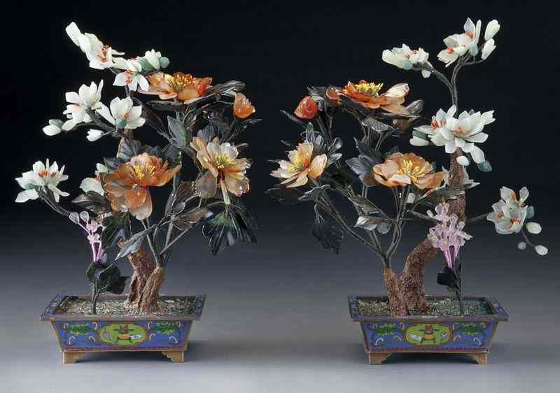 Appraisal: Pr Chinese carved jade treesdepicting peonies and magnolia set in