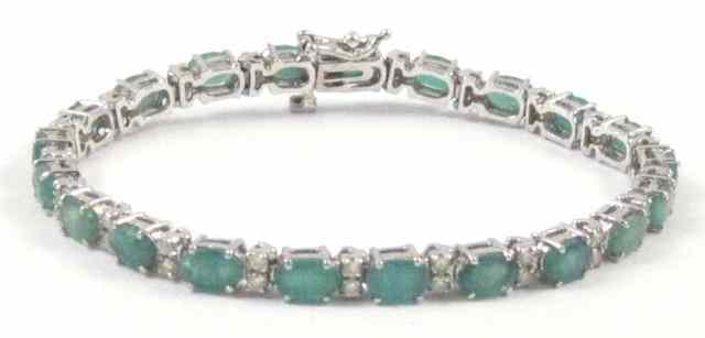 Appraisal: EMERALD AND DIAMOND BRACELET k white gold with oval-cut green