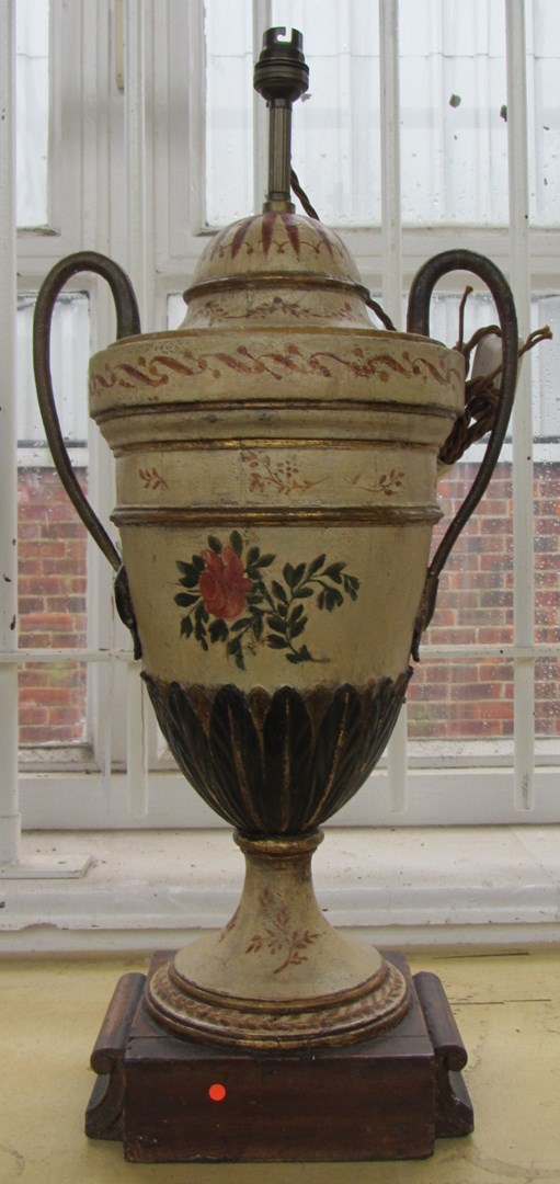 Appraisal: A carved and polychrome painted wooden lamp base of two