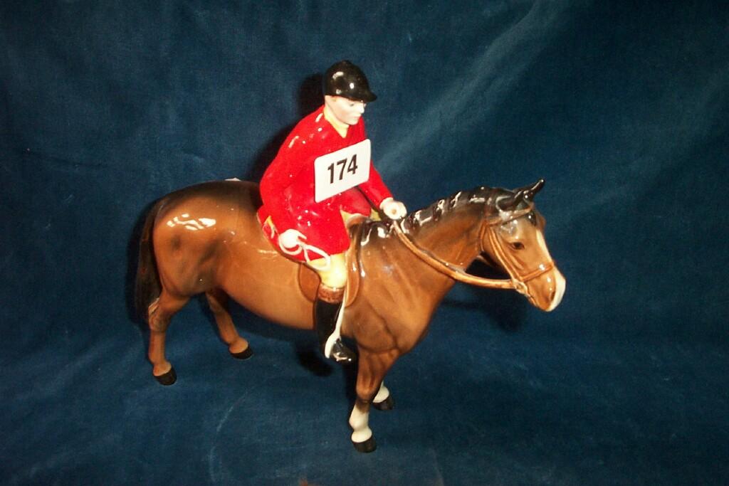 Appraisal: A Beswick group of a red jacketed huntsman on a