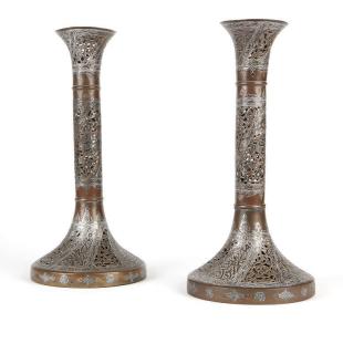 Appraisal: A pair of Indo Persian mixed metal candle holders th