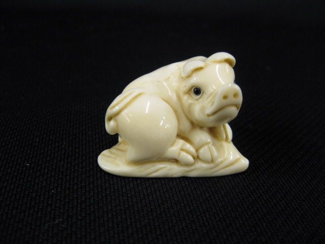 Appraisal: Carved Ivory Netsuke of a Pig onyx eyes signed excellent