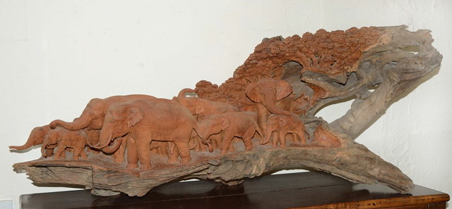 Appraisal: A LARGE CARVED GOLDEN TEAK MODEL OF A TROOP OF