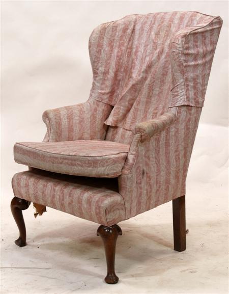 Appraisal: A th century wing back armchair the whole upholstered in