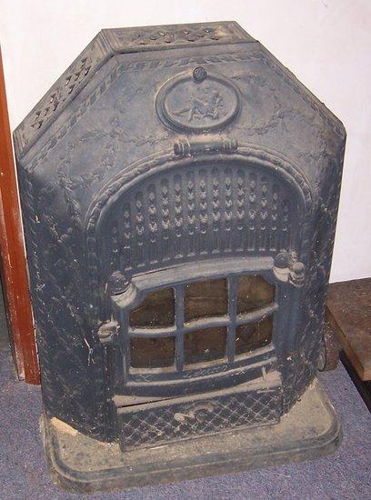 Appraisal: A cast iron tack-room stove with oval portrait to the