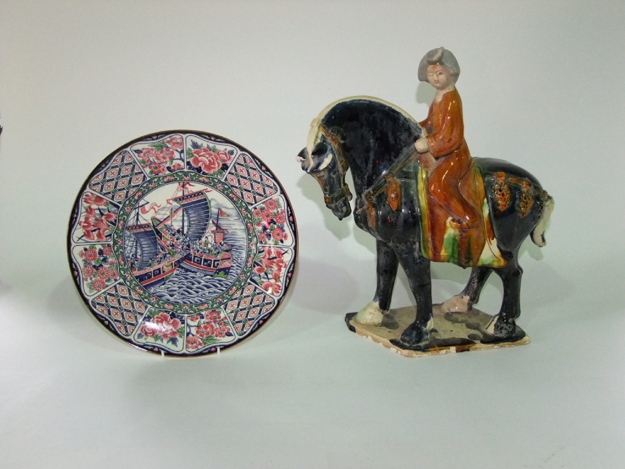 Appraisal: An oriental pottery model of a equestrian figure in the