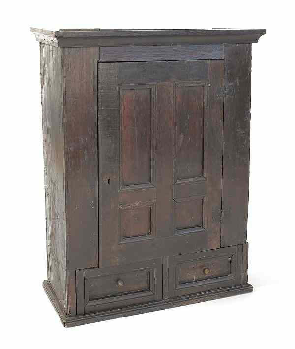 Appraisal: George II hanging oak cabinet with a paneled door over