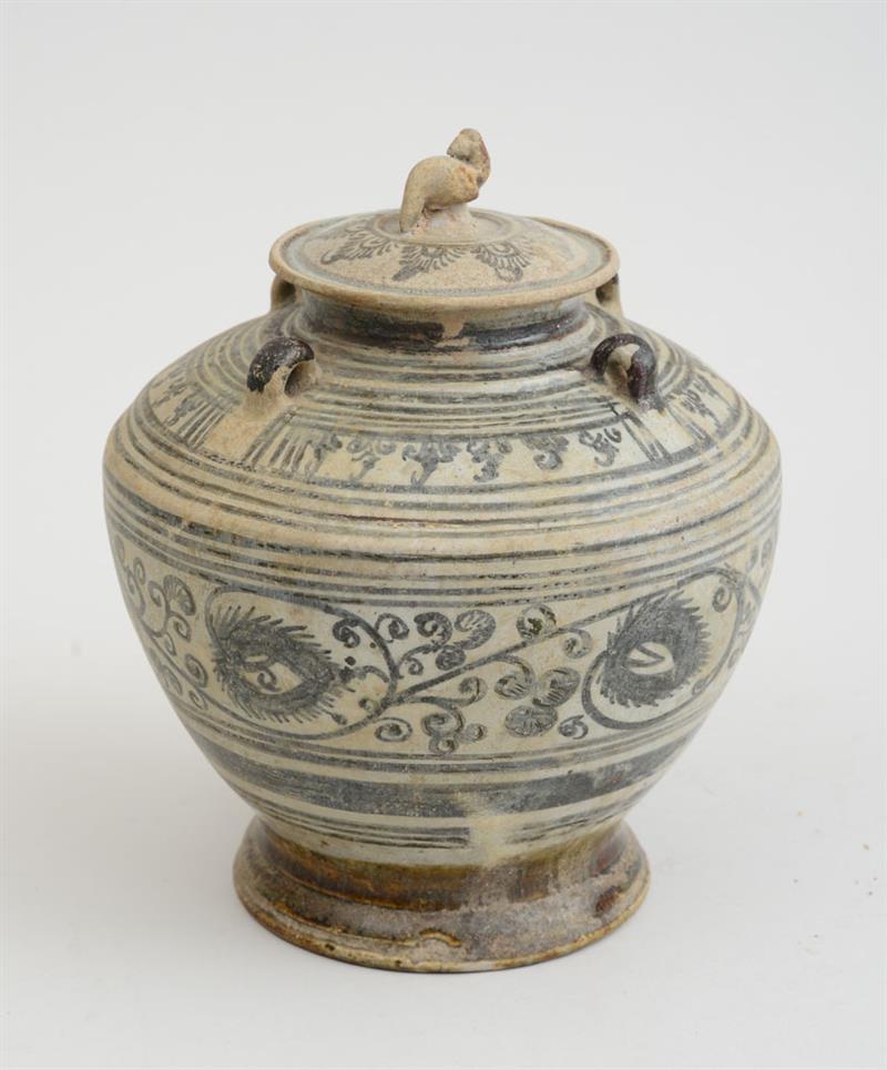 Appraisal: SOUTHEAST ASIAN BLUE-DECORATED POTTERY JAR AND COVER The ovoid footed