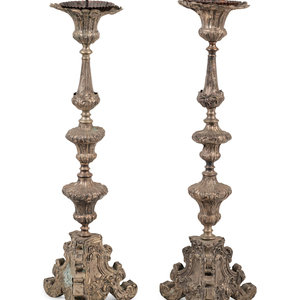 Appraisal: A Pair of Baroque Repouss Decorated Silvered Metal Pricket Sticks