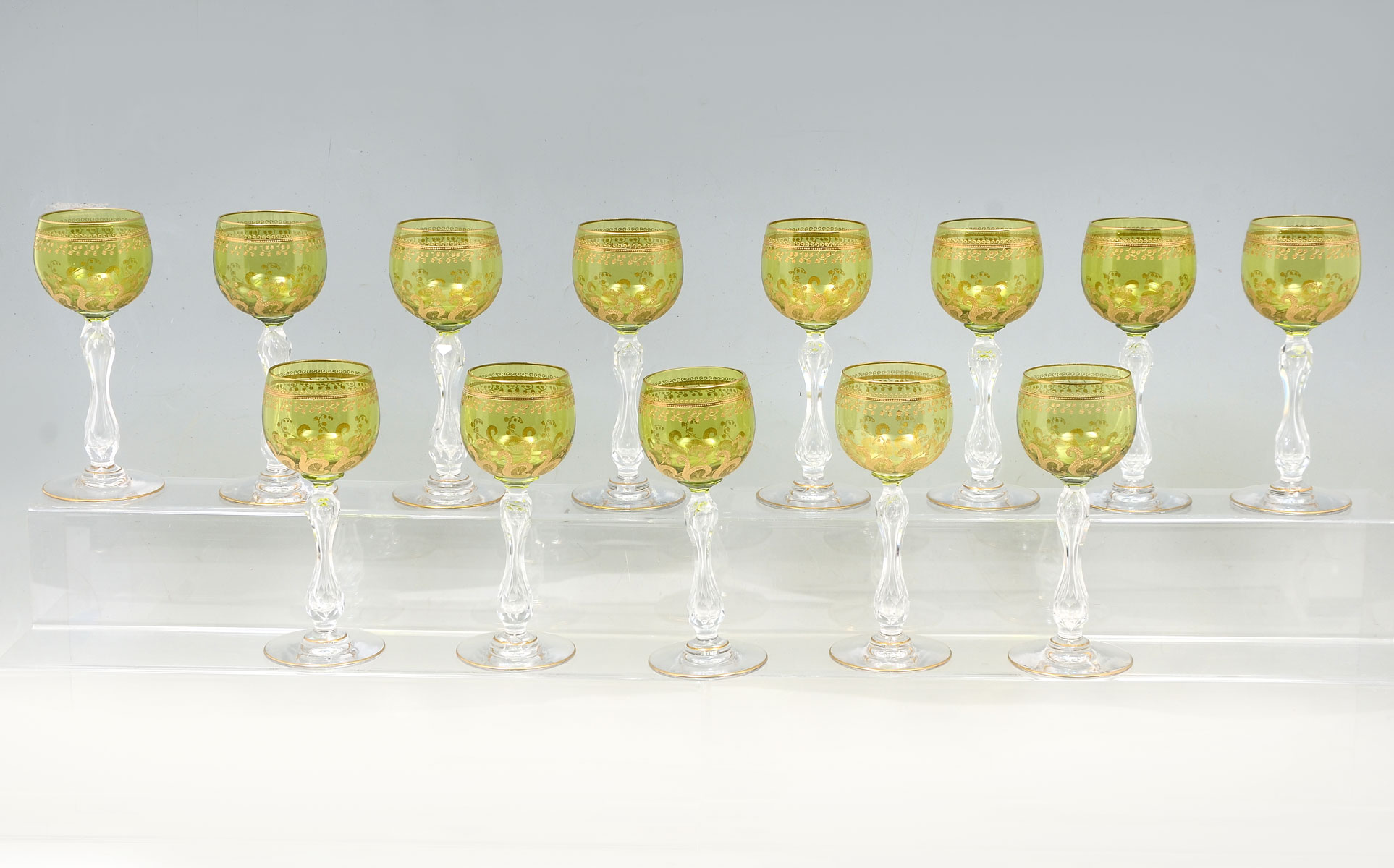 Appraisal: PC GREEN EMBOSSED GILT GLASS STEMWARE green glass wine goblets