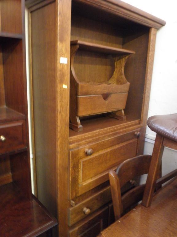 Appraisal: An oak secretaire cabinet and a similar magazine rack