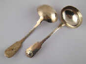 Appraisal: A pair of silver fiddle and shell sauce ladles John