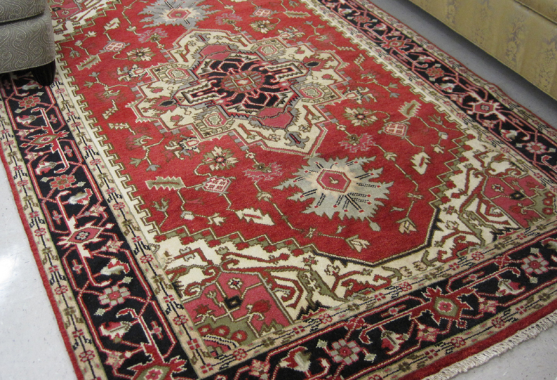 Appraisal: HAND KNOTTED ORIENTAL CARPET Persian Serapi design featuring a large