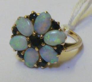 Appraisal: AN OPAL AND SAPPHIRE CLUSTER RING modelled as a flowerhead