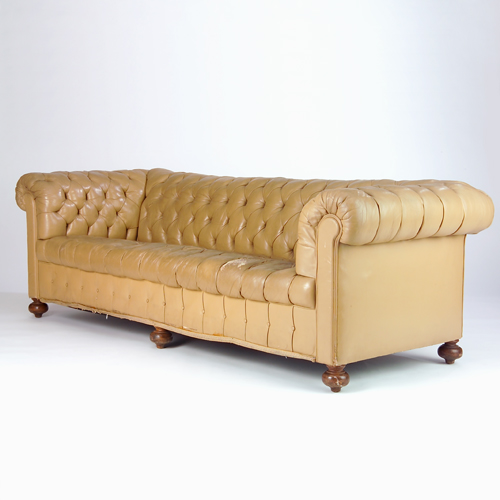 Appraisal: Chesterfield-style tufted sofa upholstered in taupe leather raised on turned