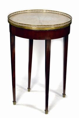 Appraisal: A mahogany gueridon the carrara marble top with a pierced