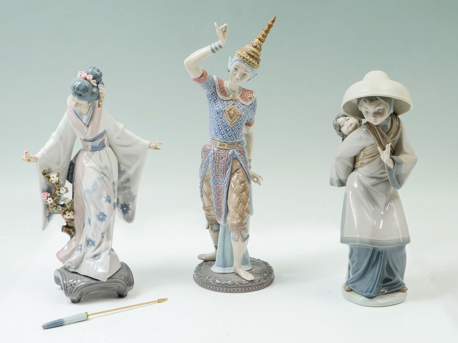 Appraisal: PIECE LLADRO FIGURES Portando Hermanito Teruko Japanese Girl with Umbrella