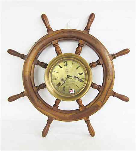 Appraisal: SHIP'S WHEEL AND ATTACHED SHIP'S CLOCK Attached to the ship's