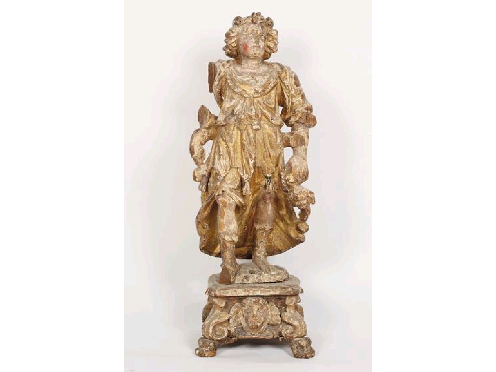 Appraisal: A BARQUE CARVED AND GILTWOOD STATUE of a figure wearing