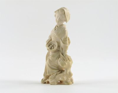 Appraisal: A Japanese ivory carving of a girl sitting on a