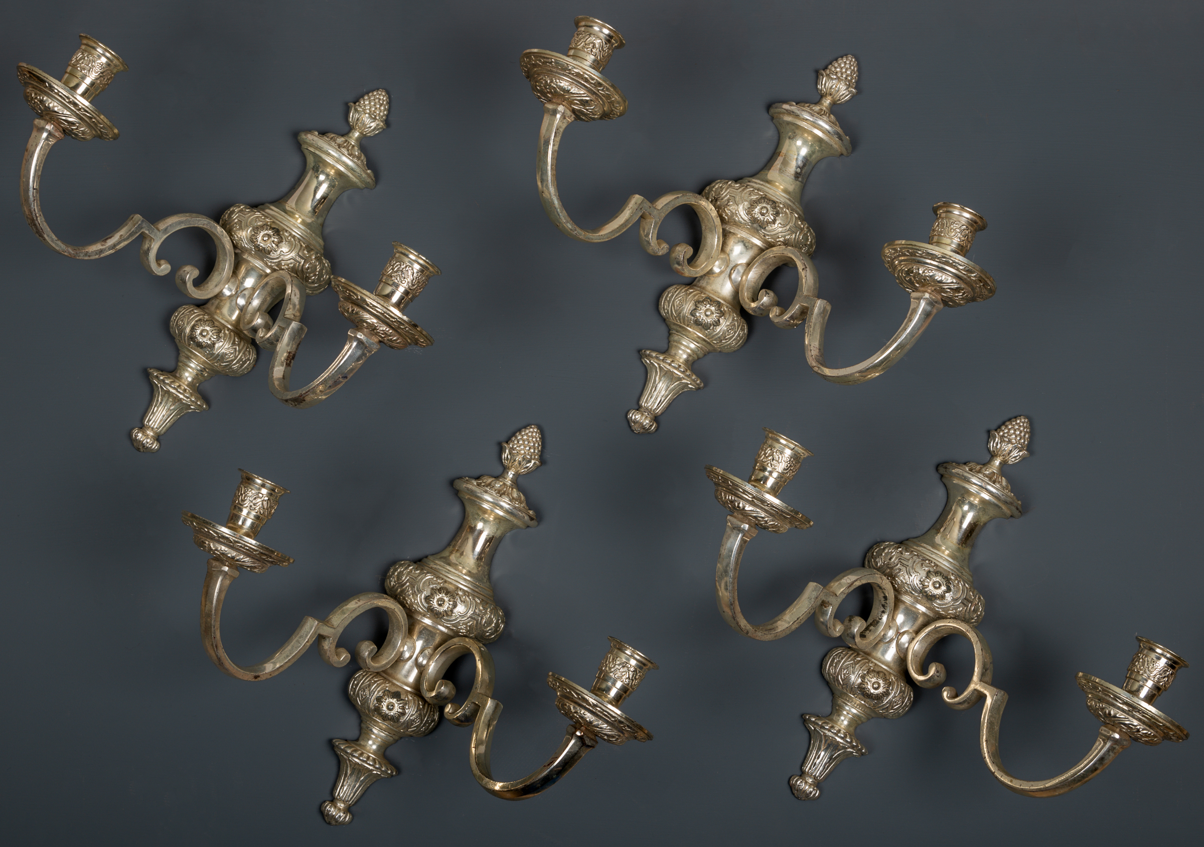 Appraisal: A set of four silver plated two-branch wall lights in