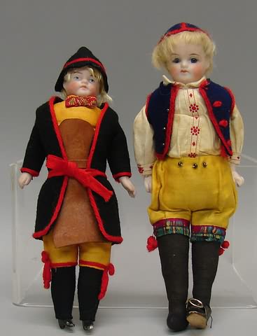 Appraisal: Pair of male tourist dolls Painted molded features shoulderhead doll