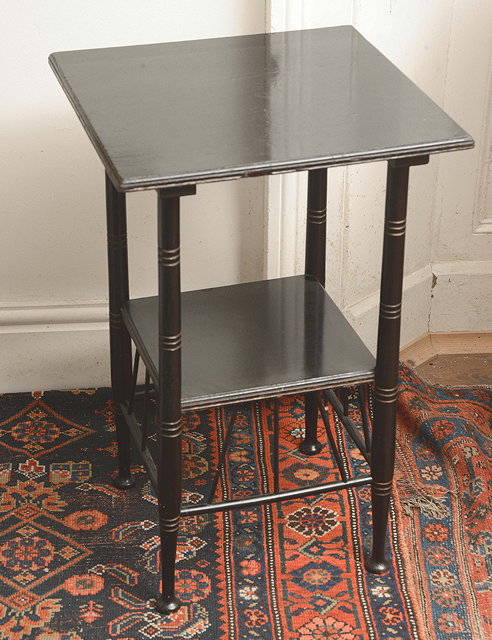 Appraisal: AN EBONISED SQUARE OCCASIONAL TABLE after a design by E