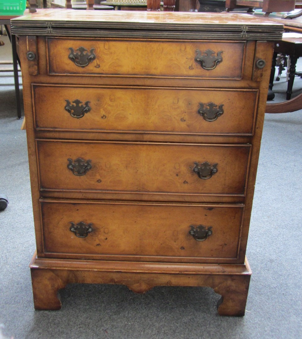 Appraisal: An th century style figured walnut bachelor's chest the foldover