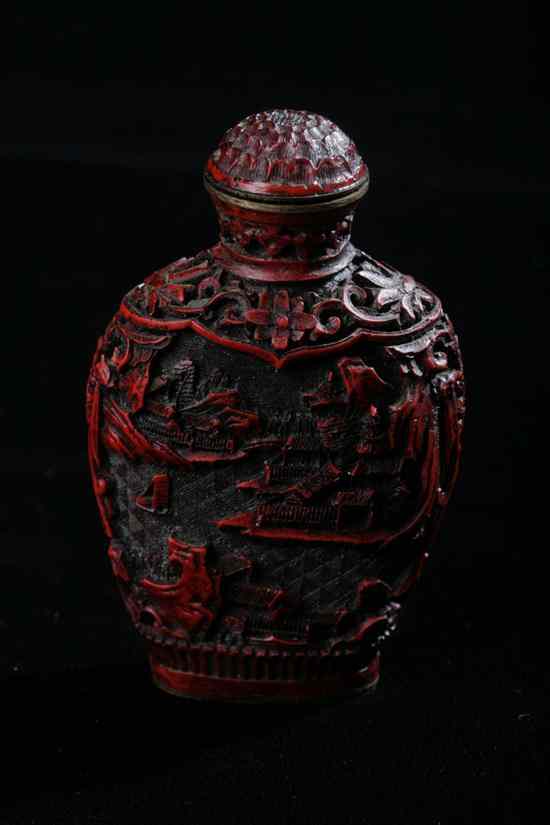 Appraisal: CHINESE CINNABAR SNUFF BOTTLE Qianlong seal mark Flattened ovoid-form carved