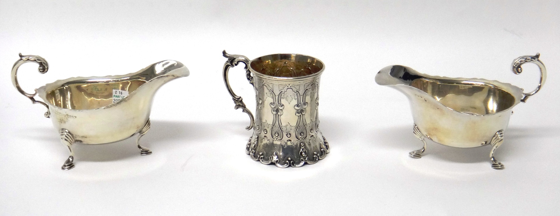 Appraisal: A Victorian silver mug with later embossed decoration and scroll