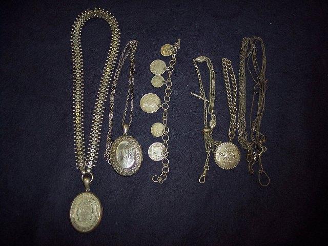 Appraisal: An oval locket on an elaborate chain another locket on