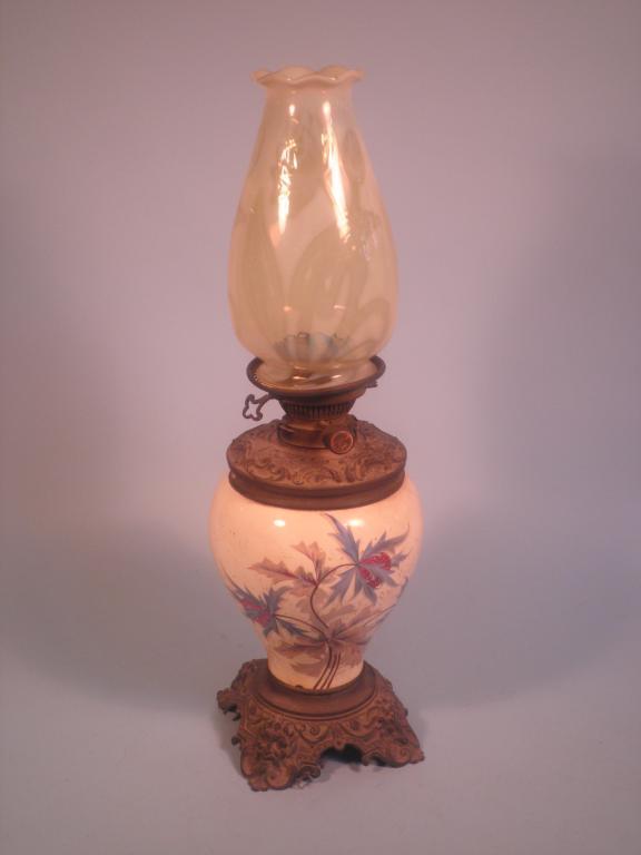 Appraisal: A Victorian oil lamp the vaseline glass shade decorated with