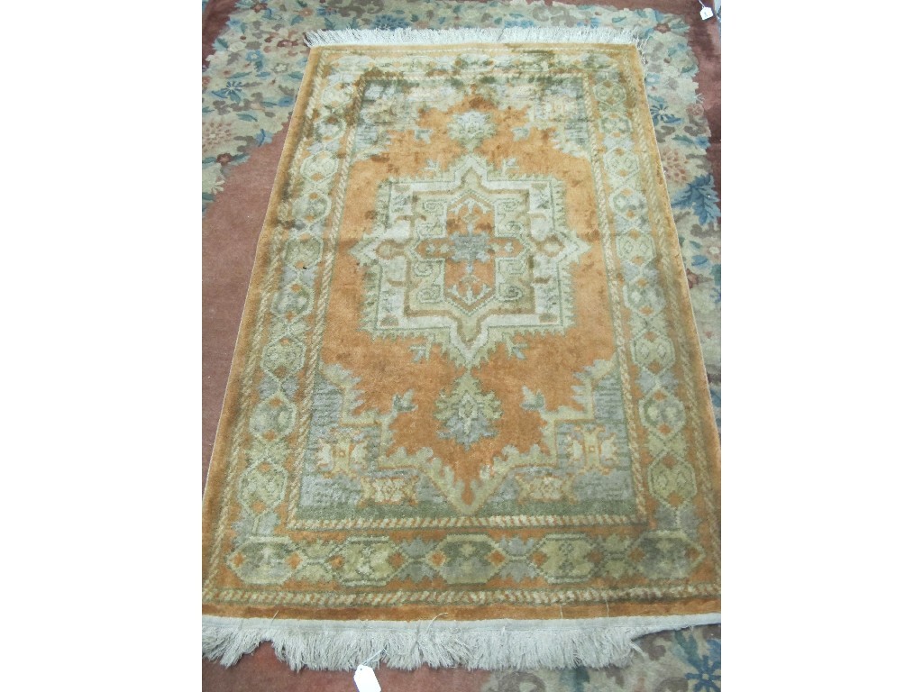 Appraisal: Eastern floor rug on orange ground Provenance The Property of