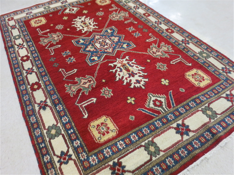 Appraisal: HAND KNOTTED ORIENTAL CARPET Indo-Kazak central geometric medallion and stylized