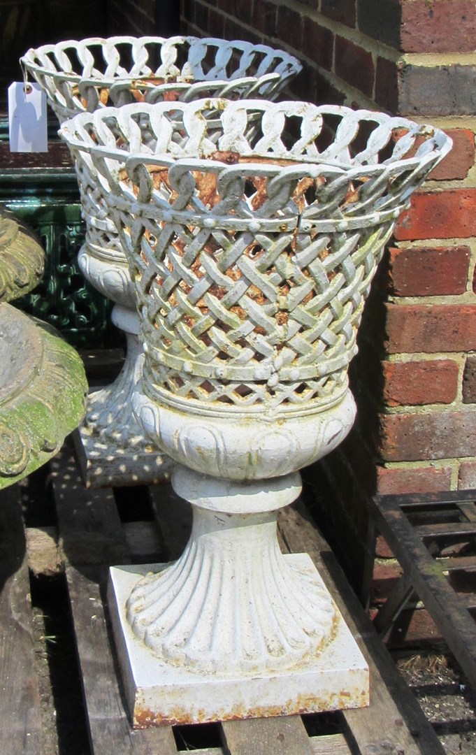 Appraisal: A pair of white painted cast iron garden urns with