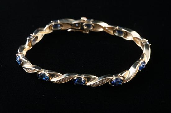 Appraisal: K YELLOW GOLD DIAMOND AND SAPPHIRE FLEXIBLE LINK BRACELET Ten