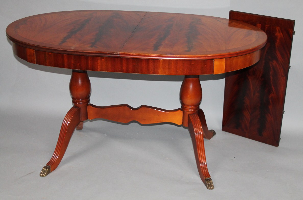 Appraisal: A flame mahogany finish D-end extending supper table of oval