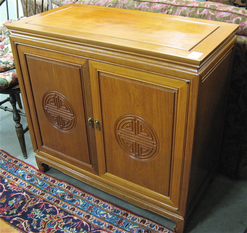 Appraisal: TEAKWOOD SIDE CABINET Chinese th century the panel doors opening