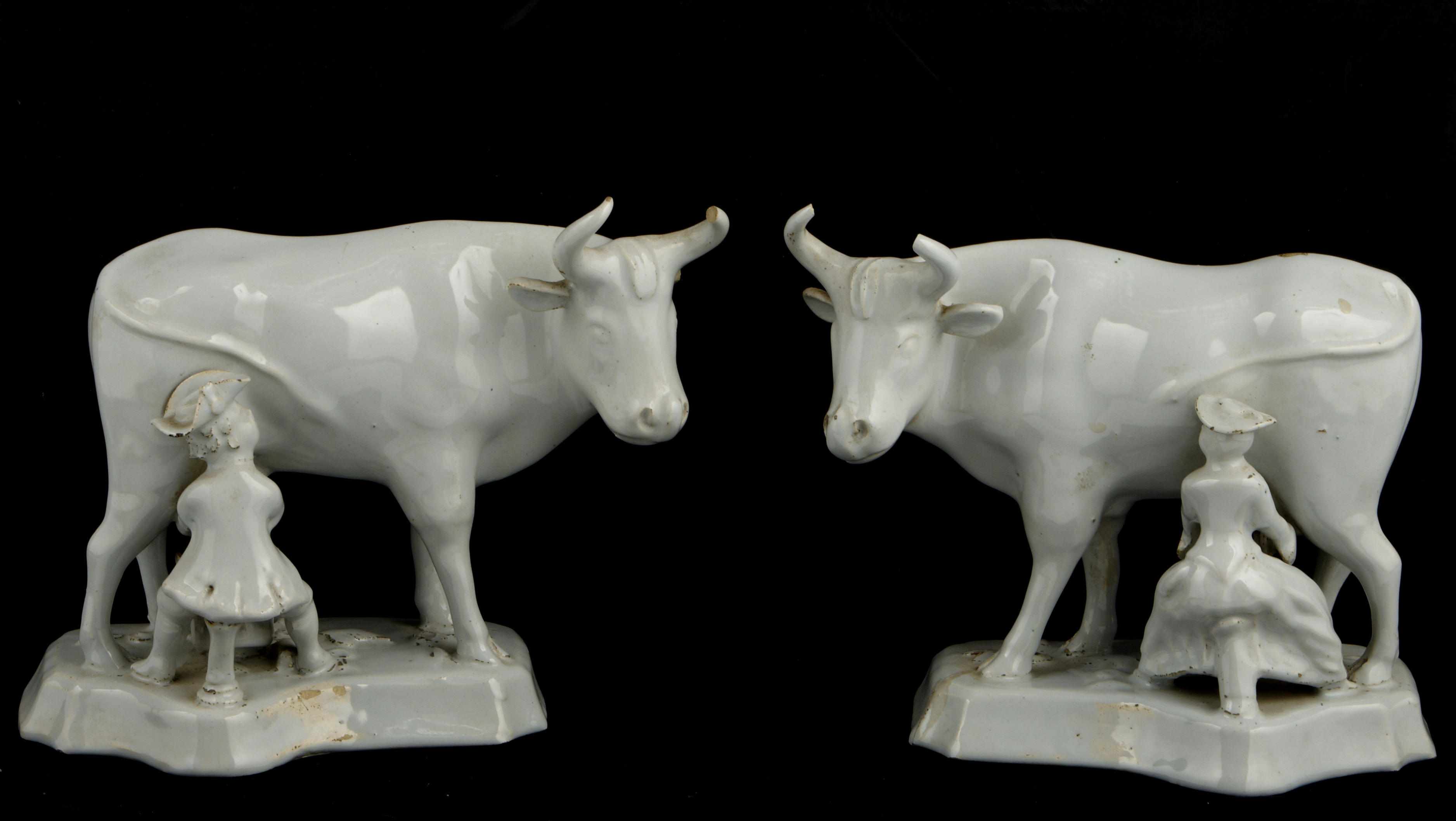 Appraisal: A pair of Continental glazed models of cows being milked