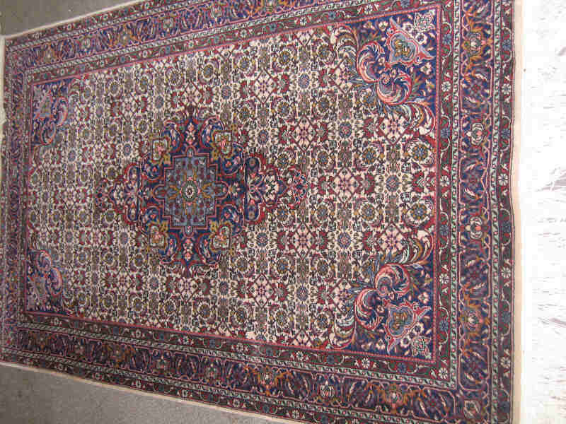 Appraisal: SINO-PERSIAN THROW RUG The ivory herati field centers an indigo