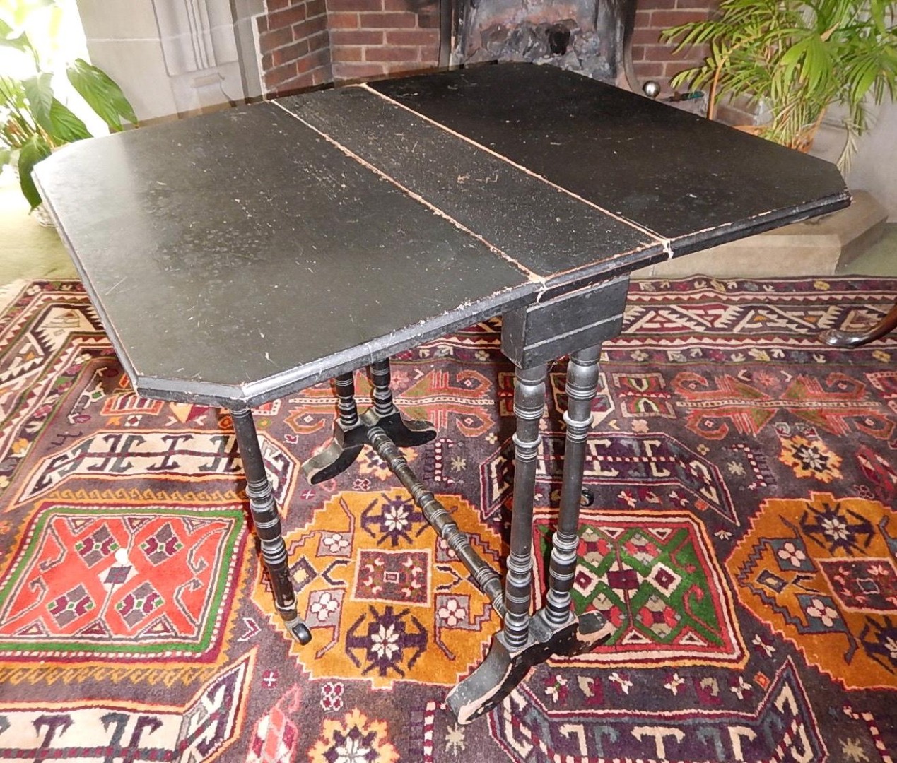 Appraisal: A Victorian ebonised Sutherland table with slender turned legs and