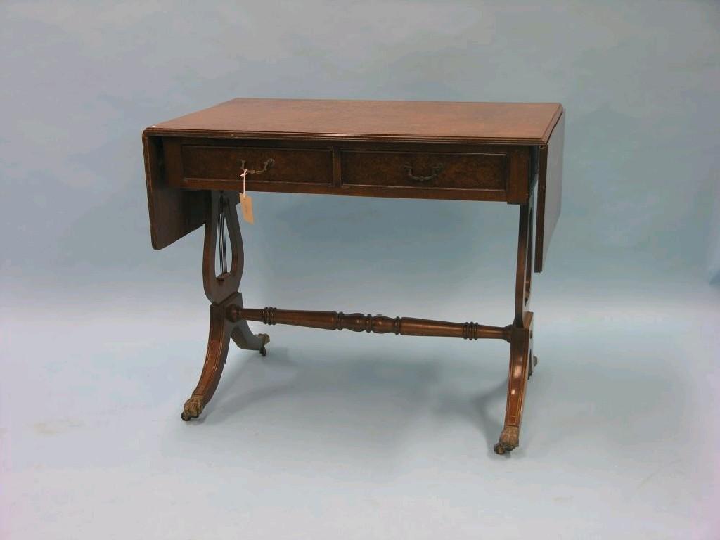 Appraisal: A reproduction burr walnut sofa table with two frieze drawers