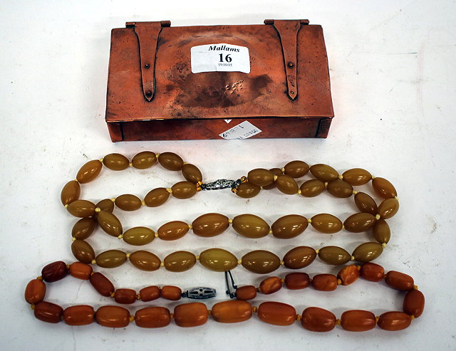 Appraisal: A BUTTERSCOTCH AMBER NECKLACE the largest bead cm in length