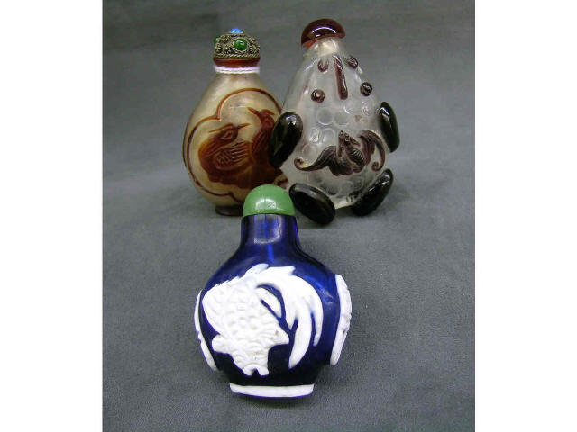 Appraisal: Three antique oriental snuff bottles with applied carvings one with