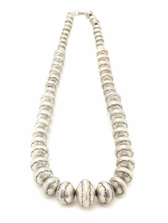 Appraisal: A Navajo Graduated Silver Bead Necklace with a flowered stamped